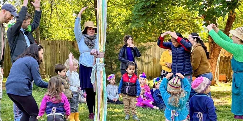 early childhood class and teachers dancing at the maypole