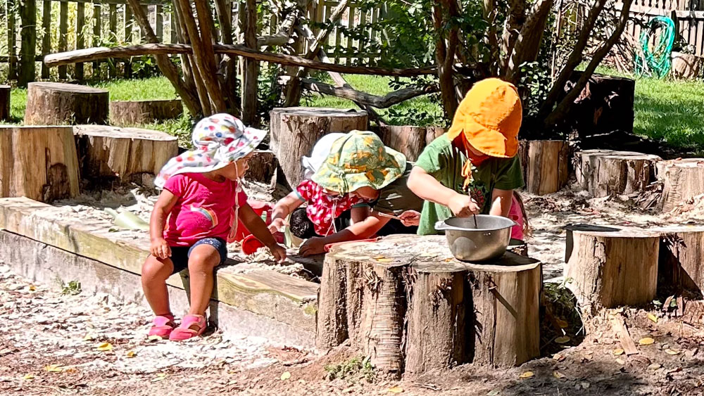 preschool students playing in the sandbox