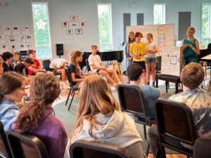 middle school students presenting information from their environmental science class