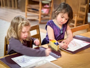 early childhood students drawing with beeswax crayons