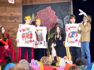actors in grade school class play Alice in Wonderland