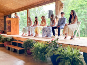 8th grade students on stage while school director speaks
