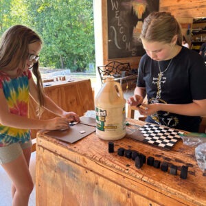 middle school students making chess boards