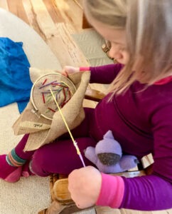 early childhood student stitching