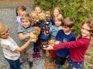 first grade students with their knitted cats