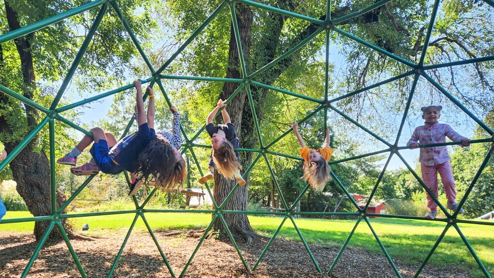 first grade children on the playground structure