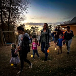 families walking together with lit lanterns