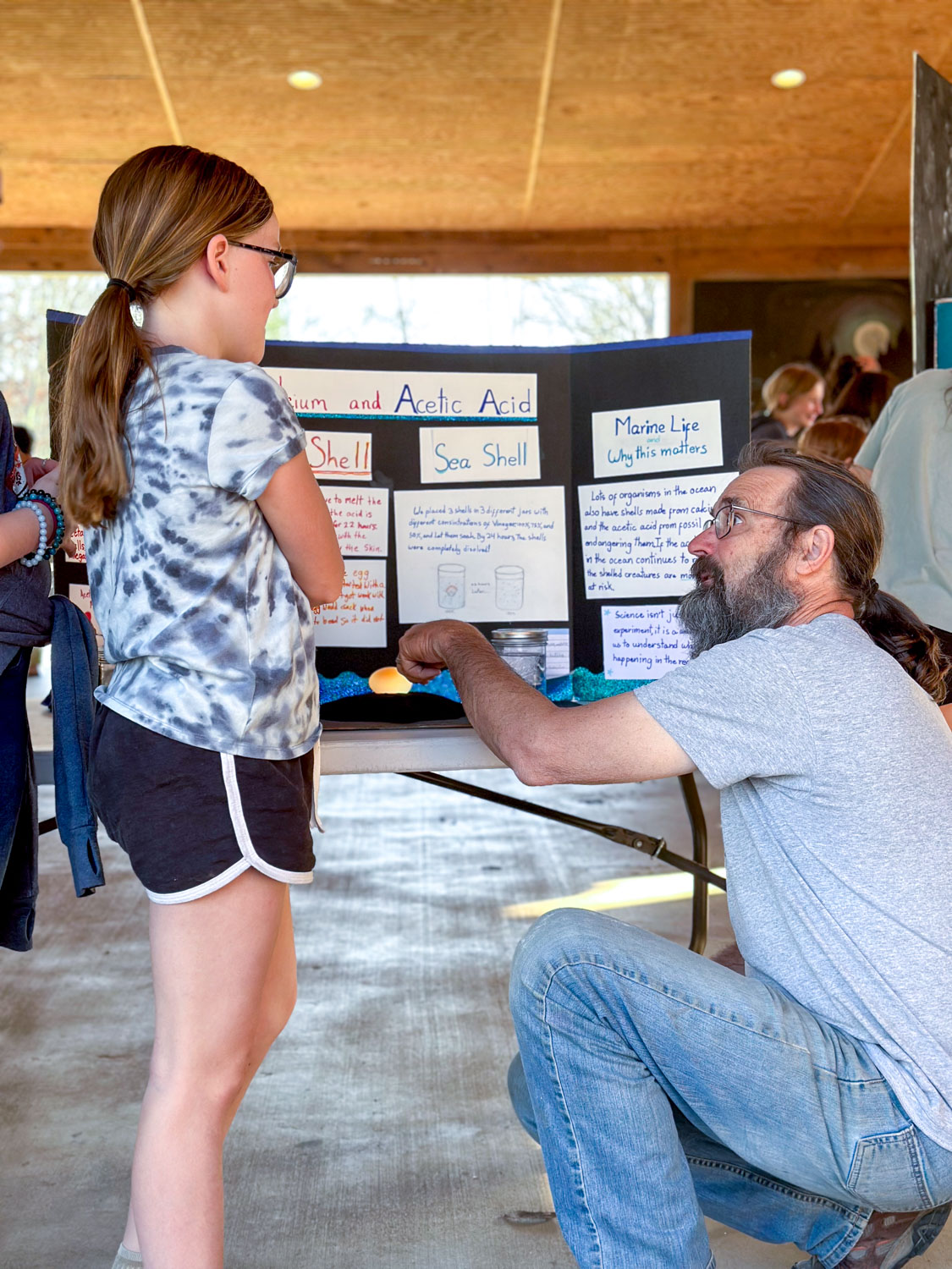 middle school student explaining science fair project