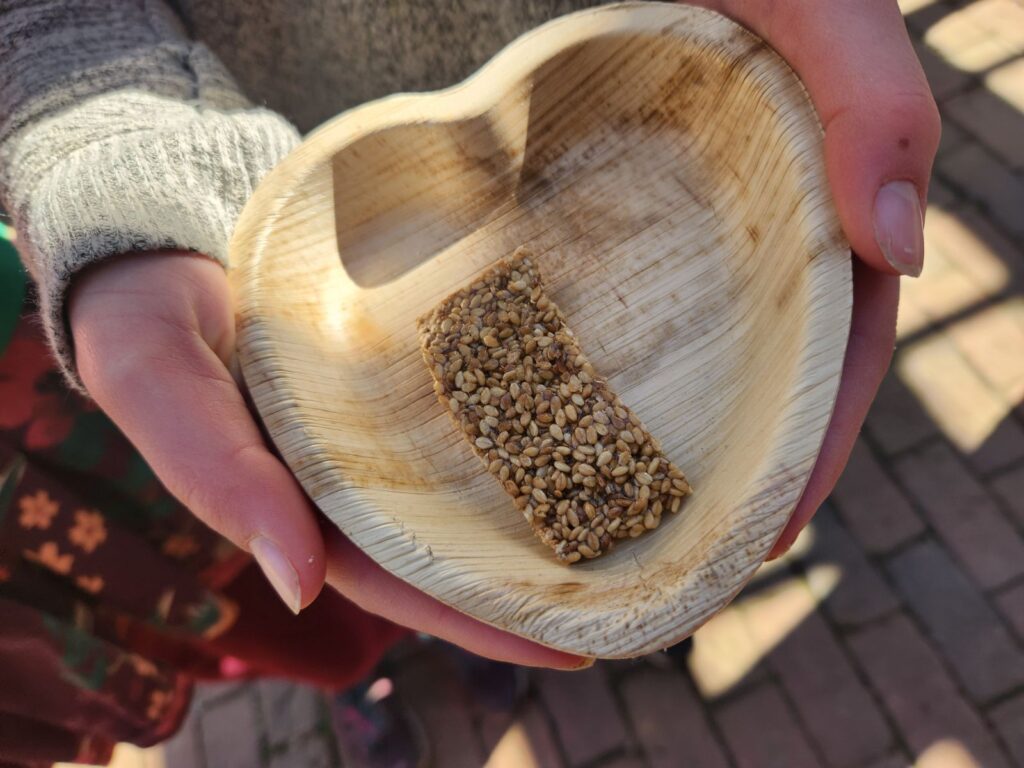 heart shaped wooden bowl in student hands holding a bar