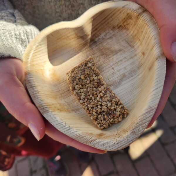 heart shaped wooden bowl in student hands holding a bar