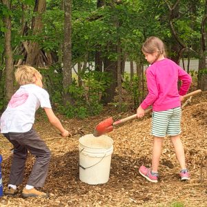 earth day students digging mulch