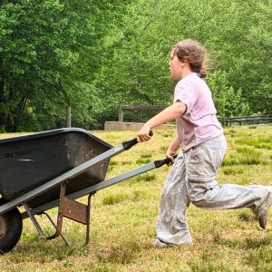 earth day students with a wheelbarrow