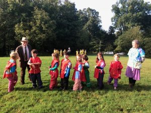 group photo of the Charlottesville Waldorf School (CWS) class of 2026 in first grade performing in the Michaelmas Pageant