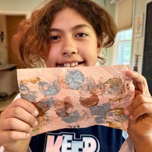 cws elementary student holding artwork