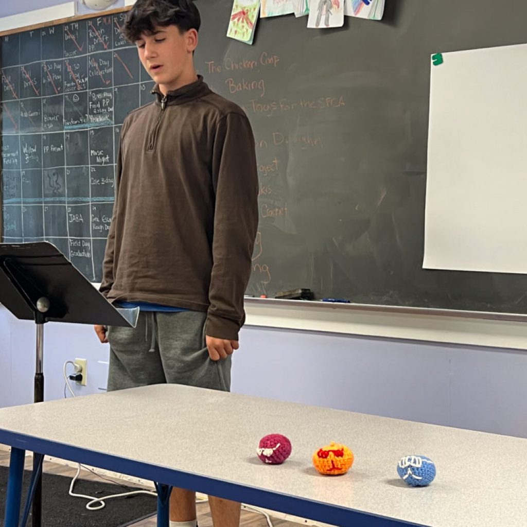 Eighth grade student presenting Passion Project about crochet and making toys for children in the PICU