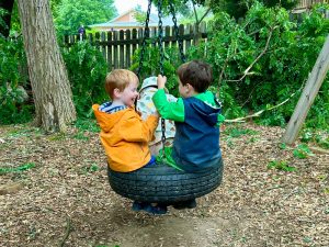 Toddlers on a tire swing at Charlottesville Waldorf School(CWS)